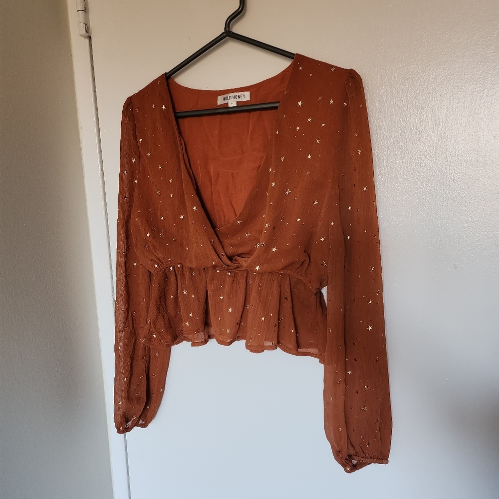 Orange V Neck peplum top with gold star details Size Medium